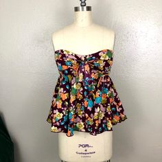 Deep Purple Floral Strapless Top With Circle Bottom & Bow A Fun And Flirty Floral Top With A Self Tie Bow. The Fitted Bust Highlights The Empire Waist And The Flowy Bottom Is A Forgiving Silhouette. The Pop Of Colors Makes It Perfect For Spring. Invisible Zipper Closure. If You Have Any Additional Questions, Feel Free To Message Me. Measurements: Length: 16" Bust: 32 1/2" Beyonce T Shirt, Red Sports Bra, Lululemon Align Tank, Purple Tee, Colorful Crop Tops, Ruffle Tank Top, Embroidery Top, Bathing Suit Cover Up, Crop Top Bra