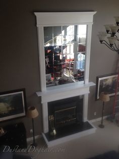 a living room with a fireplace and pictures on the wall