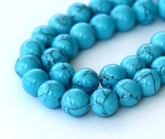 a strand of turquoise beads on a white surface