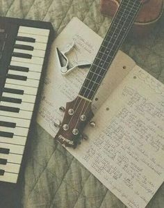 an electric guitar sitting on top of a sheet music