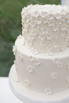 a white wedding cake with flowers on it