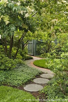 a garden with stepping stones and trees