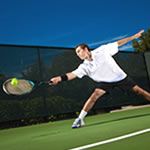 a man swinging a tennis racquet at a ball