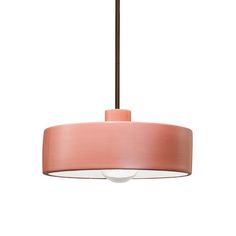 a pink lamp hanging from a ceiling fixture