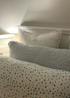 a bed with two lamps on either side of it