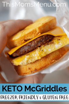 a person holding a hamburger with cheese and egg