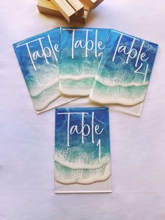 four coasters with the words table and wave on them