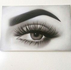 an eye with long lashes is shown in this black and white photo on the wall