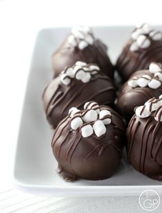 chocolate covered candies on a white plate