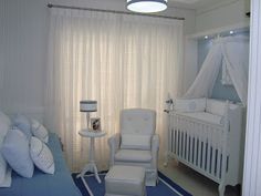 a baby's room with blue carpet and white furniture