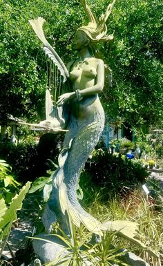 a statue of a mermaid holding a fish