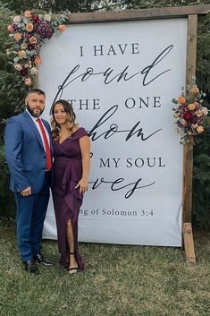 a man and woman standing in front of a sign that says i have found the one who my soul loves