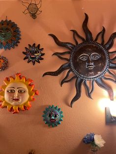 the sun and moon faces are hanging on the wall