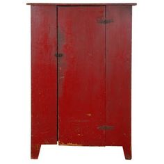 an old red wooden cabinet with two doors