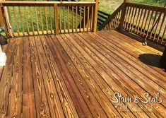 a wooden deck with railings in the background