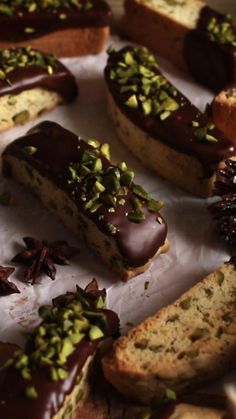 chocolate and pistachio covered doughnuts are on display