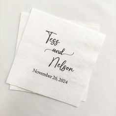 two wedding napkins with the names and date printed on them