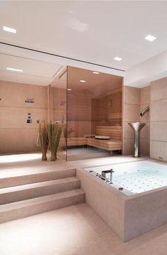 a bathroom with a large jacuzzi tub next to stairs