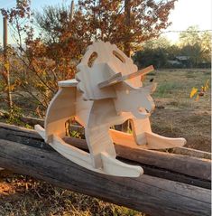 a wooden sculpture sitting on top of a log