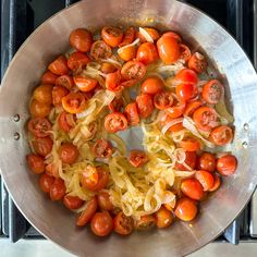 tomatoes and onions cooking in a pan on the stove