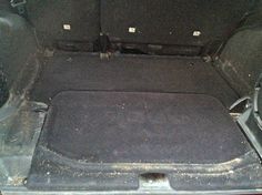 the back end of a car with its trunk and seat removed from it's floor