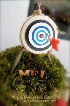 a close up of a small toy target on top of moss