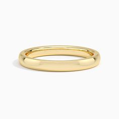 a yellow gold wedding ring on a white background