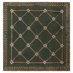 a green rug with an intricate design on it