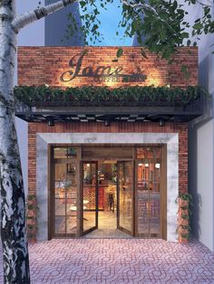 an entrance to a restaurant with brick walls and glass doors that lead into the dining area