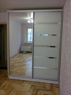 an empty room with a sliding glass door and hard wood flooring on the side