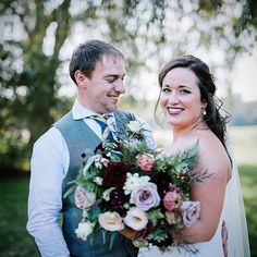 a bride and groom smile at each other