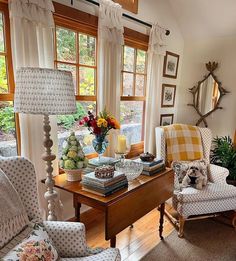 a living room filled with furniture and lots of windows