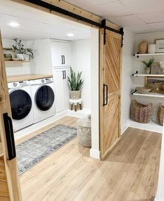 an open door leading to a washer and dryer in a room with wooden floors