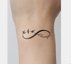 a woman's arm with a tattoo on it that says always and two birds flying in the sky