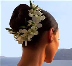 the back of a woman's head with flowers in her hair and text that reads, click here full resolution