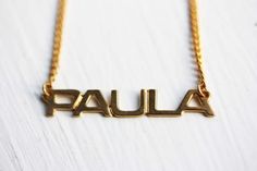 This is an awesome vintage name necklace from about the 70s! It is 14K Gold Plated and has never been worn.The name is about 1.5" wide.Model shown wearing “Marie” name necklace.NOTE: This CAN NOT be custom made. They are vintage, thus you will receive the exact same name in the photo above. We have lots of vintage name jewelry in the shop! You can see them all here at this link:https://www.etsy.com/shop/diamentdesigns/search?search_query=name&order=date_desc&view_type=gallery&ref=sho Vintage Silver Name Necklace, Vintage Personalized Nameplate Necklace, Personalized Vintage Nameplate Necklace, Vintage Nameplate Necklaces, Vintage Custom Name Jewelry Nameplate, Vintage Custom Name Nameplate Jewelry, Vintage Custom Nameplate Jewelry, Vintage Gold Name Necklace, Vintage Nameplate Necklace For Anniversary