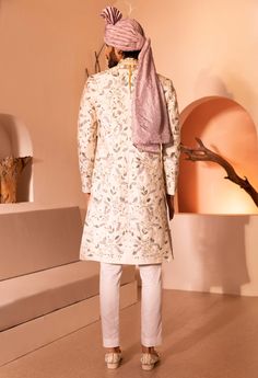 Featuring rustom sherwani set in raw silk with intricate hand embroidery all over the sherwani with bead, cutdana, and thread work. Off White Naqshi Sherwani For Diwali, Ceremonial Sherwani With Intricate Embroidery In Raw Silk, Festive Straight Kurta Sherwani With Naqshi, Semi-stitched Raw Silk Sherwani With Intricate Embroidery, Elegant Art Silk Bandhgala With Chikankari Embroidery, Transitional Raw Silk Sherwani With Intricate Embroidery, Semi-stitched Embroidered Jamawar Sherwani, Art Silk Sherwani With Resham Embroidery Customizable, Embroidered Semi-stitched Jamawar Sherwani