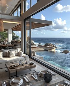 a living room filled with furniture next to the ocean