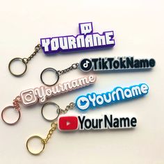 four different colored key chains with the words your name on them