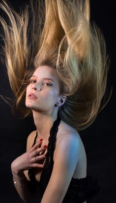 a woman with her hair blowing in the wind