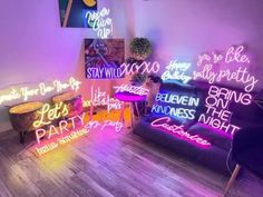 neon signs are lit up in the corner of a room