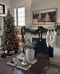 a living room decorated for christmas with stockings hanging from the fireplace