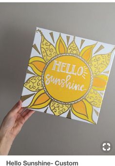 someone holding up a card with the words hello sunshine on it in front of a gray background