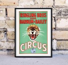 an old circus poster is hanging on a brick wall next to a stone wall with a leopard's head