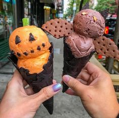 two ice cream cones with halloween decorations on them