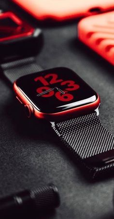 an apple watch sitting on top of a table next to other accessories and gadgets