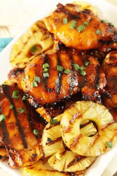 grilled chicken and pineapples on a white plate