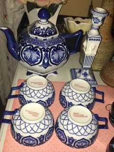 a blue and white tea set on a table