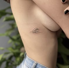 a woman with a small tattoo on her stomach