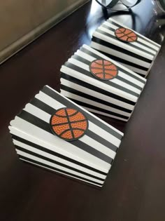 basketball themed party boxes with black and white stripes, orange ball on the top one